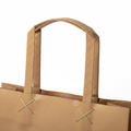 Bolsa de papel kraft marrón con asas planas 32x44 cm fuelle 16 cm para transporte de producto en tienda